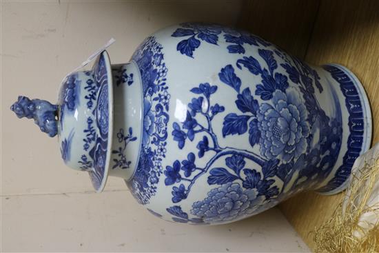 A Chinese blue and white painted lidded baluster vase, painted with blossoming peonies height 45cm, cracked